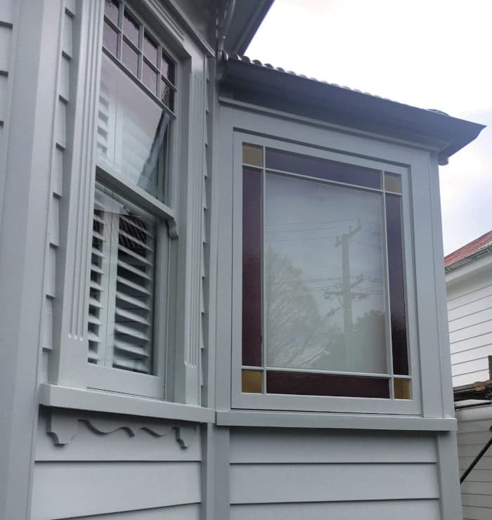 Wooden windows with stained glass and louvres